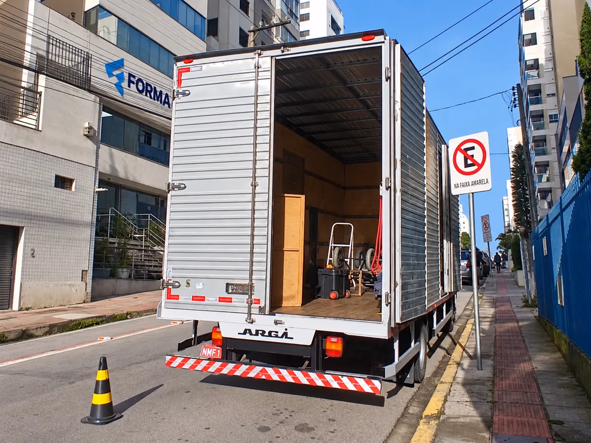 Caminhão de mudanças com compartimento aberto em uma rua da cidade
